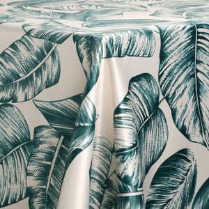 May include: White tablecloth with a green tropical leaf pattern. The leaves are drawn in a detailed, realistic style.