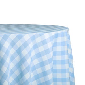 May include: A light blue and white checkered tablecloth. The fabric is draped over a round surface, with the pattern creating a diagonal grid. The color scheme is a soft, pastel blue and white.