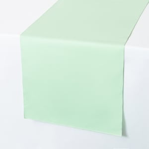 May include: A light green table runner. The runner is made of a smooth fabric and is perfect for adding a touch of color to your table setting.
