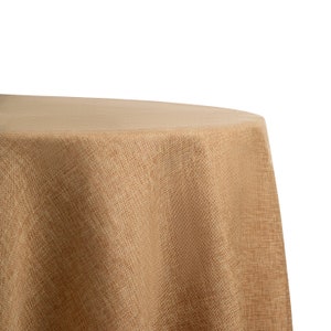 May include: A round, brown burlap tablecloth with a textured weave. The tablecloth is draped over a table and has a smooth, even surface.