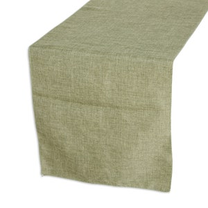 May include: A green linen table runner. The runner has a subtle texture and a light green color.