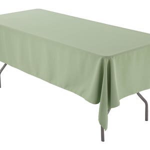 May include: A sage green rectangular tablecloth draped over a table with silver legs.