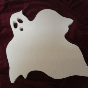 May include: A white, ghost-shaped decoration with three eye holes. The Halloween-themed cutout is made of a light-colored material and has a simple, rounded design. Perfect for seasonal crafts and decorations.