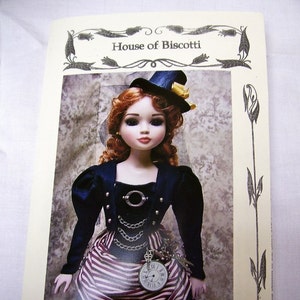 May include: A 16-inch doll wearing a steampunk outfit with a black and white striped skirt, a black jacket with gold accents, and a black top hat with a gold band. The doll has red hair and blue eyes. The image is from House of Biscotti and is titled "16" Ellwyne and 43cm BJD Steampunk Outfit".