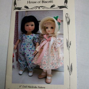 May include: A pattern booklet for an 8-inch doll wardrobe. The cover features a floral design and the text "House of Biscotti". The booklet includes patterns for a playsuit, skirt, blouse, three dresses, panties, bonnet, and beret.