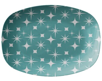 May include: A teal oval serving platter with a white starburst pattern.