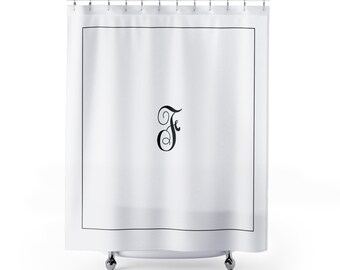May include: White shower curtain with a black border and a large, elegant black letter "F" in the center. The curtain hangs from a metal rod with rings and is set against a white background.