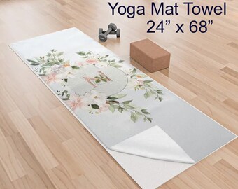 May include: A gray yoga mat towel with a floral design and the letter "H" in a circle. The towel is 24 inches by 68 inches.
