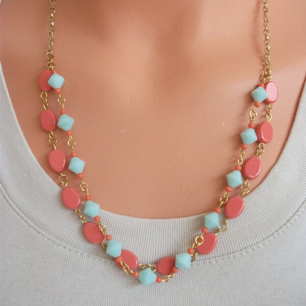 Spring and summer, you got them covered with this necklace of pressed coral ovals and swarovski mint bicones.  Semi double strand