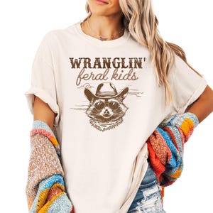 Wranglin&#39; Feral Kids Comfort Colors® Shirt | Funny Graphic T-Shirt for Mom | Raccoon Cowboy Oversized Tee | Short Sleeve Shirt for Mama