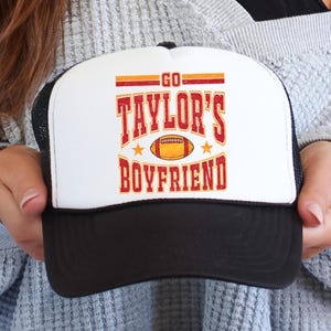 Go Taylor&#39;s Boyfriend Trucker Hat for Women and Teens | Funny Travis Football Fan Adjustable Cap | Red and Gold Team Graphic Snapback