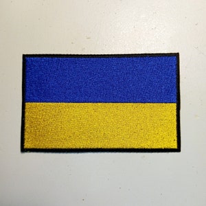 May include: A blue and yellow embroidered patch of the Ukrainian flag.
