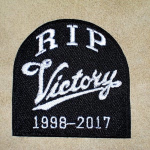 May include: Black and white embroidered patch with the words "RIP Victory 1998-2017".