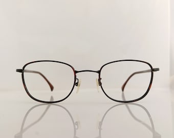 May include: A pair of brown and black spectacles with a rectangular frame.