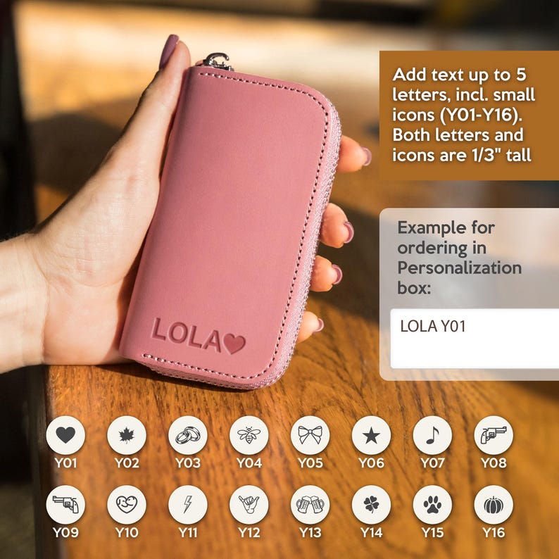 Custom engraved leather key pouch with initials and small icons, personalized key holder gift for him or her. A pink leather key chain with a zipper closure. The keychain is 1/3 inch tall and can be personalized with up to 5 letters and a small icon.  There are 16 icons to choose from, including a heart, maple leaf, rings, bee, bow, star, musical note, gun,  a heart with an arrow, lightning bolt, shaka sign, beer mugs, clover, paw print, and a pumpkin.
