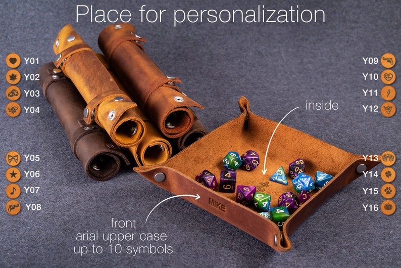 May include: A set of brown leather dice trays and rolling cases. The trays have a personalized name "MIKE" and the cases have a space for up to 10 symbols. The image shows a variety of symbols that can be used for personalization.