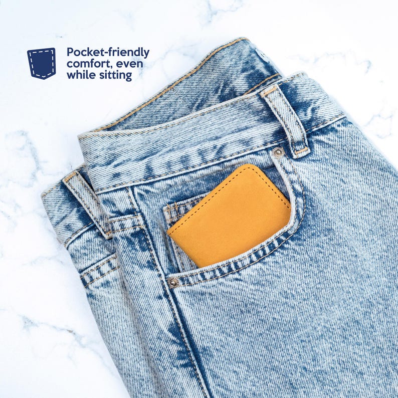 May include: A yellow leather wallet in the front pocket of a pair of light blue denim jeans. "Pocket-friendly comfort, even while sitting" is written in blue text on a white background.
