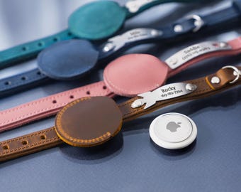 May include: Five leather dog collars with metal tags engraved with names and phone numbers. The collars are in different colors: teal, blue, pink, brown, and white. A white Apple AirTag is also visible.