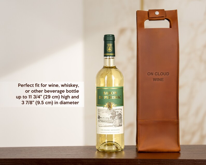 Leather wine bottle carrier shown next to standard wine bottle illustrating fit for anniversary wine gift and romantic dinner presentation