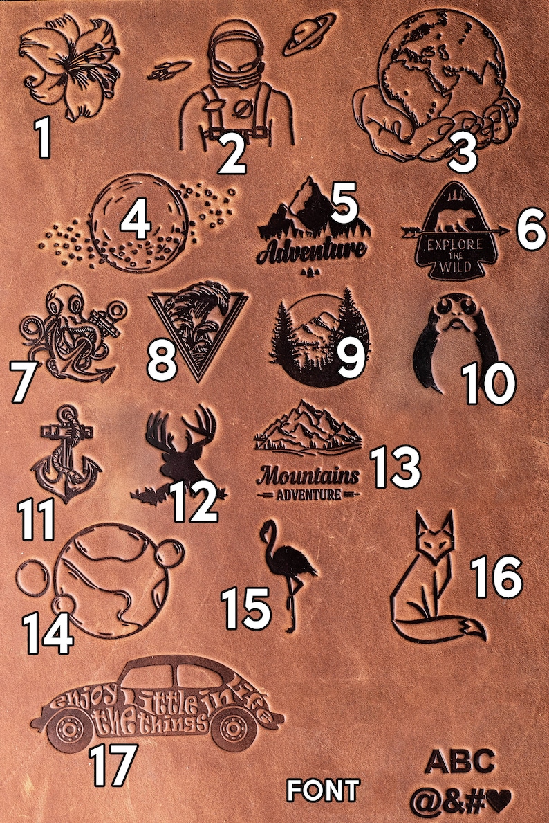 May include: A brown leather sheet with 17 different designs, including a flower, an astronaut, a globe, a moon, a mountain, a bear, an octopus, a wave, a forest, a robot, an anchor, a deer, a flamingo, a fox, a planet, a car, and a font sample. The designs are numbered 1 through 17.