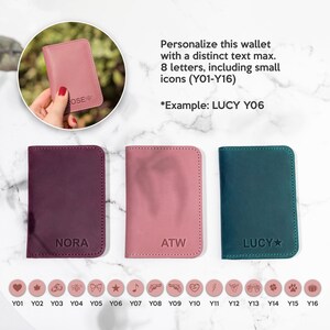 May include: Three leather wallets in different colors: burgundy, pink, and teal. Each wallet has a different name on it: Nora, ATW, and Lucy. The wallets are displayed on a white marble surface. Below the wallets are 16 small icons that can be added to the wallets.