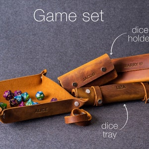 May include: A brown leather game set with a dice tray, dice holder, and a ring. The tray is labeled "Alice", the holder is labeled "Marry", and the ring is labeled "Jacob".