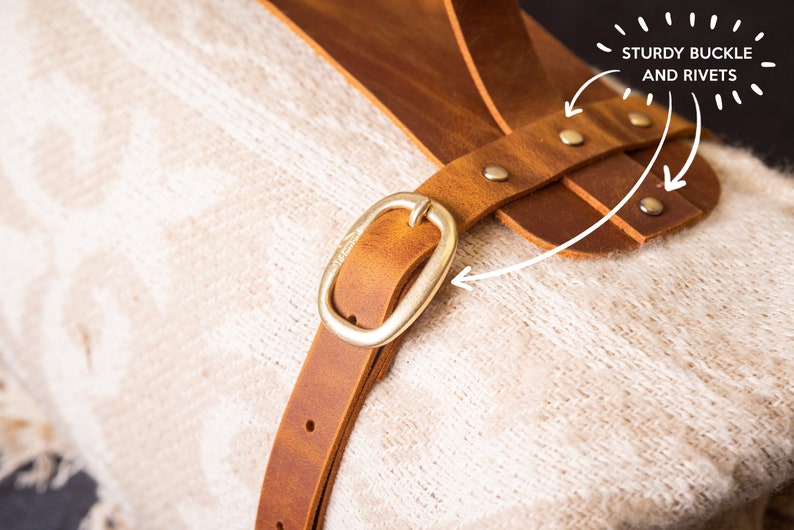 Close up of sturdy buckle and rivets on leather blanket carrier, durable anniversary gift for outdoors loving couple