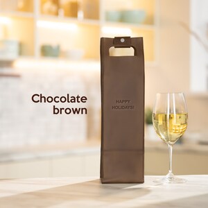 Chocolate brown personalized leather wine carrier engraved with custom message, meaningful anniversary wine gift for couples displayed in modern home setting