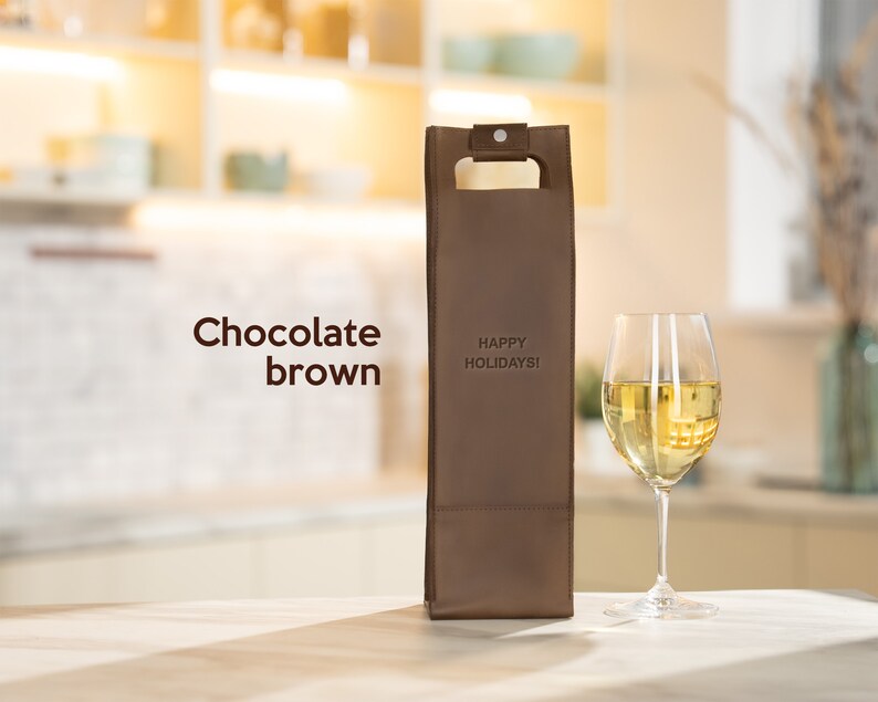 Chocolate brown personalized leather wine carrier engraved with custom message, meaningful anniversary wine gift for couples displayed in modern home setting