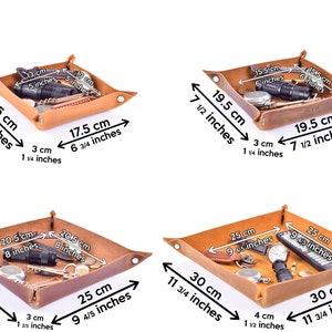 May include: Four brown leather trays of different sizes, each with a folded edge and a stitched border. The trays are filled with various small items, such as keys, a flashlight, and a remote control. The trays are labeled with measurements in both inches and centimeters.
