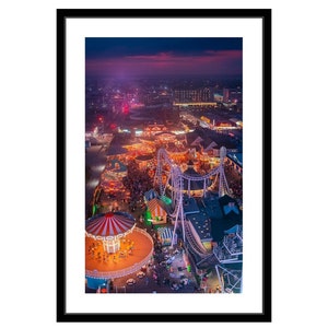 May include: An aerial view of a brightly lit amusement park at night. The park is filled with colorful rides, including a carousel, a roller coaster, and various other attractions. The lights create a festive atmosphere, and the park is bustling with activity.