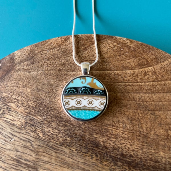 Turquoise and teal Circular China Mosaic Pendant. Upcycled Vintage Plate Shard and Millefiori Set in Round Bezel.