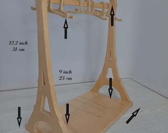 Clothes hanger for a doll rack for a doll