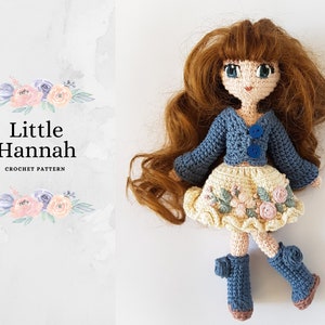 May include: Crocheted doll with brown hair, blue eyes, and a blue cardigan over a yellow floral skirt. The doll is wearing blue boots and has a sweet expression. The doll is named "Little Hannah" and is a crochet pattern.