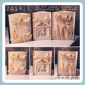 May include: Three folded book sculptures, each depicting a different scene from the Christmas story. The first sculpture shows the words "Silent Night" with a star and a manger scene. The second sculpture shows the words "Silent Night" with a star and a manger scene. The third sculpture shows the words "Silent Night" with a star and a manger scene. The text "2019" and "All in the folds" are also visible in the image.