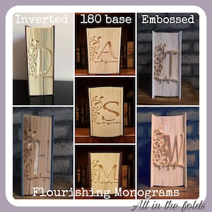 May include: A collage of six images showing different styles of book folding, each featuring a different letter of the alphabet. The letters are A, D, H, M, S, and W. The text "Flourishing Monograms" and "All in the folds" is at the bottom of the image.