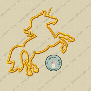 May include: A gold outline of a unicorn with a single horn, standing on its hind legs with its tail raised. The unicorn is outlined in a thick, gold thread.