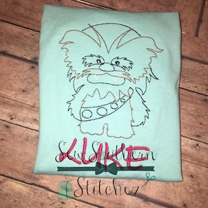 May include: A light blue t-shirt with an embroidered image of Chewbacca from Star Wars. The text "Sew Southern" is embroidered below the image.