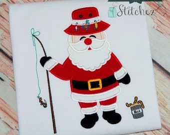 May include: Embroidered design of a Santa Claus wearing a red and white fishing hat, holding a fishing rod with a worm on the line. He is wearing a red suit with a black belt and white trim. He is standing next to a small bucket of bait.