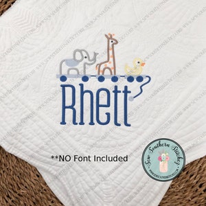 May include: White baby blanket with a blue embroidered name "Rhett" and a whimsical design of a giraffe, elephant, and duck on a train. The blanket has a quilted pattern and a "Sew Southern Stitchez" logo in the corner.