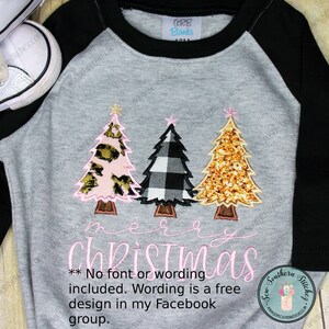 May include: A gray raglan style shirt with black sleeves featuring three Christmas trees. The trees have pink leopard print, black and white buffalo check, and gold glitter designs. The words "merry christmas" are embroidered in pink.