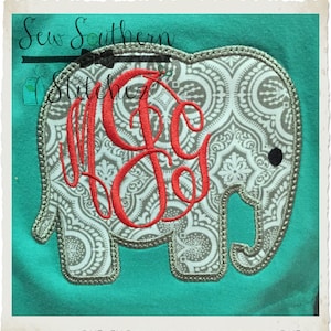 May include: A gray elephant applique with a white and gray paisley pattern. The elephant has a red monogram in the center. The applique is on a turquoise background.