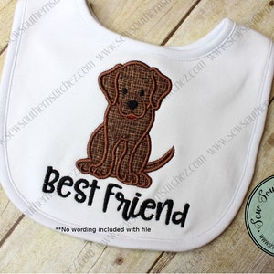 May include: White baby bib with brown embroidered dog and the text "Best Friend".