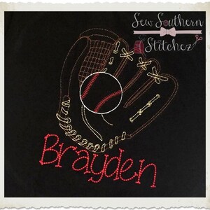 May include: Embroidered baseball glove and ball design with the name "Brayden" in red thread on a black fabric background. The design is for a personalized item.