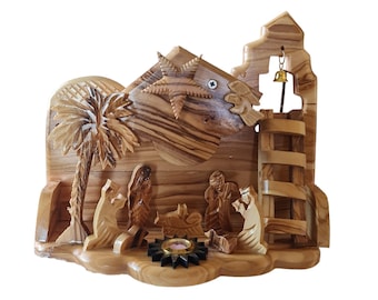 May include: A hand-carved wooden nativity scene with a star, palm tree, and figures of Mary, Joseph, and baby Jesus. The scene is made of olive wood and has a rustic, natural look.