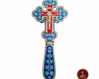 May include: A gold-colored cross with blue and red enamel detailing. The cross features a depiction of Jesus Christ on the front. The cross is decorated with floral patterns and the inscription "IC XC NIKA" in Cyrillic script.