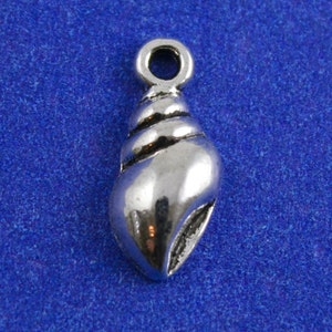 May include: A silver seashell charm with a loop at the top for attaching to jewelry or other crafts.