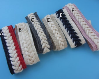 May include: Six different braided cotton trims with various colors, including red, white, gray, beige, navy blue, and pink. The trims are arranged horizontally on a blue background.