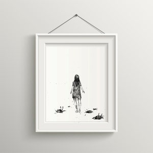 May include: Framed black and white art print. The artwork depicts a person standing with their back to the viewer, surrounded by several dark shapes. The print is in a white frame, hanging on a white wall.