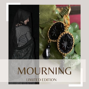 May include: Black and gold earrings with a star-shaped design and black teardrop accents. The earrings are labeled "Mourning Limited Edition".
